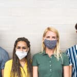 Multiracial friends wearing face mask for preventing and stop corona virus spread – Youth millennial generation lifestyle during covid-19 crisis